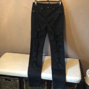 Size 4 Black stretchy jeans with holes in each leg.